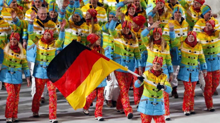 Maria Hoefl-Riesch of Germany carries her country flag as the team arrives during the opening ceremony of the 2014 Winter Olympics in Sochi, Russia, Friday, Feb. 7, 2014. (AP Photo/Petr David Josek)