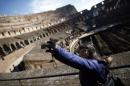 A woman takes a picture of herself in Rome's ancient Colosseum