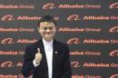 Alibaba founder and chairman Jack Ma poses for media while touring the CeBIT trade fair in Hanover