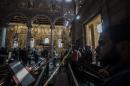 Egyptian security forces (L) inspect the scene of a bomb explosion at the Saint Peter and Saint Paul Coptic Orthodox Church on December 11, 2016, in Cairo's Abbasiya neighbourhood