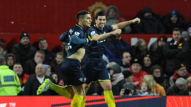 Southampton's Serbian midfielder Dusan Tadic (L) celebrates scoring a goal during the English Premier League football match between Manchester United and Southampton at Old Trafford in Manchester, England, on January 11, 2015