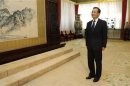 Chinese Premier Wen Jiabao waits for Egypt's President Mohamed Mursi before their meeting in the Great Hall of the People in Beijing