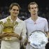 Roger Federer of Switzerland holds his winners trophy and Andy Murray of Britain holds his runners-up trophy after Federer defeated Murray in their men's singles final tennis match at the Wimbledon Tennis Championships in London