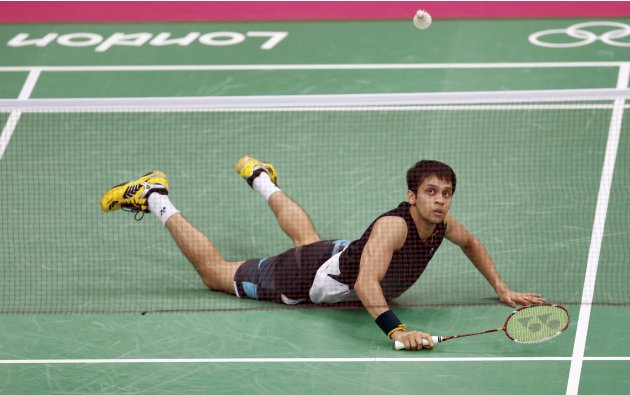 India's Kashyap Parupalli looks at a shuttlecock as he falls during his mens singles badminton quarterfinals match against Malaysia's Chong Wei Lee during the London 2012 Olympic Games at the Wembley 