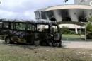 A still image from video of a fire damaged vehicle outside the national assembly building in Libreville, Gabon