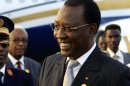 Chad president Idriss Deby smiles after arriving at Khartoum Airport on an official visit
