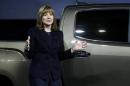 Mary Barra, incoming CEO of General Motors Co., reveals the 2015 GMC Canyon pickup truck in an industrial building in advance of the media preview of the North American International Auto Show in Detroit,