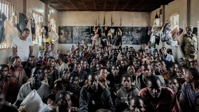 Some of the 200 Ethiopian nationals detained for illegal immigration, sit on the floor of the prison in Lilongwe, Malawi