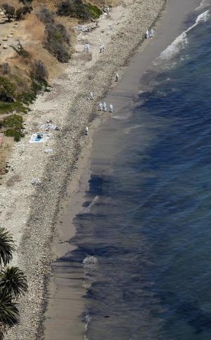 Clean-up crews work at the site of an oil spill at &hellip;