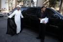 Bahrain's Al-Wefaq opposition group leader Sheikh Ali Salman (L) arrives at the office of the Bahrain public prosecutor for questioning in Manama, on November 3, 2013