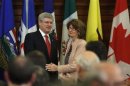 Canada's PM Harper shakes hands with Government Leader in the Senate LeBreton after delivering a speech during a Conservative caucus meeting on Parliament Hill in Ottawa