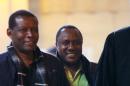 Claude Muhayimana (C), one of the two Rwandan men accused of taking part in the massacre of ethnic Tutsis during the Rwandan genocide, arrives for an extradition hearing at the courthouse in Paris, on November 13, 2013