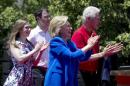 Chelsea Clinton, husband Marc Mezvinsky, U.S. Democratic presidential candidate Hillary Clinton and former President Bill Clinton stand onstage at a campaign kick off rally in Franklin D. Roosevelt Four Freedoms Park on Roosevelt Island in New Y