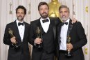 Grant Heslov, from left, Ben Affleck, and George Clooney pose with their award for best picture for "Argo" during the Oscars at the Dolby Theatre on Sunday Feb. 24, 2013, in Los Angeles. (Photo by John Shearer/Invision/AP)