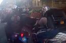 In this frame grab from video provided by the New York Police Department, motorcyclists ride alongside a sport utility vehicle, Sunday, Sept. 29, 2013, in New York. Police say that a man driving with his family along a New York City highway was attacked and beaten by a large group of motorcyclists who first surrounded his sport utility vehicle and stopped it on the road, then chased him for miles after he plowed through the blockade of bikes in an attempt to escape. (AP Photo/New York Police Department)