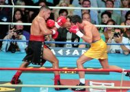 In this Sept. 13, 1997, photo provided by Las Vegas News Bureau, Hector Camacho, left, fights Oscar De La Hoya in a boxing match at Thomas and Mack Center in Las Vegas. Camacho's family tried to decide Wednesday, Nov. 21, 2012, whether he should be removed from life support after a shooting in his Puerto Rican hometown left the former boxing champion clinging to life and his fans mourning the loss of a dynamic and often troubled athlete. (AP Photo/Las Vegas News Bureau, Darrin Bush)