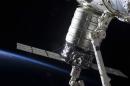 Attached to the Harmony node, the first Cygnus commercial cargo spacecraft built by Orbital Sciences Corp., in the grasp of the Canadarm2