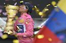 Colombia's Nairo Quintana kisses the trophy after winning the Giro D'italia, Tour of Italy cycling race, from Gemona to Trieste, Sunday, June 1, 2014. Nairo Quintana confirmed himself as cycling's next star by winning the Giro d'Italia on Sunday to follow his runner-up finish in last year's Tour de France. The 24-year-old climbing specialist with the Movistar team won two stages and finished with a 3 minute, 7 second advantage over fellow Colombian Rigoberto Uran for his first Grand Tour victory. Italy's Fabio Aru finished third overall, 4:04 back. (AP Photo/Fabio Ferrari)