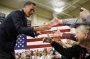 Former Republican presidential candidate Mitt Romney meets with attendees at a Republican presidential candidate, Ohio Gov. John Kasich campaign stop on Monday, March 14, 2016, at Westerville Central High School in Westerville, Ohio. (AP Photo/Matt Rourke)