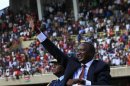 Kenya's President Kenyatta waves as he leaves after his swearing-in ceremony at Kasarani Stadium in the capital Nairobi
