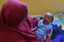 Ubah Mohamed Ali, 30, holds her 3 month old son Mohamed who is suffering from pneumonia, at the SAACID stabilization centre in Mogadishu