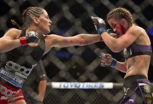 Jessica Eye, left, battles against Leslie Smith at UFC 180 in Mexico City. (AP)