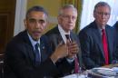 Senate Minority Leader Mitch McConnell of Ky., right, and Senate Majority Leader Harry Reid of Nev., center, listen as President Barack Obama speaks during a meeting with Congressional leaders in the Old Family Dining Room of the White House in Washington, Friday, Nov. 7, 2014. (AP Photo/Evan Vucci)