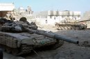 Syrian army tanks are seen deployed in the Jobar neighbourhood of Damascus on August 24, 2013