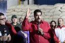 Venezuela's Vice President Maduro talks to the media during a visit to Fama de America's coffee processing plant in Caracas