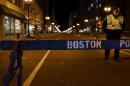 A Boston police officer stands near the scene of a twin bombing at the Boston Marathon, on April 16, 2013 in Boston, Massachusetts