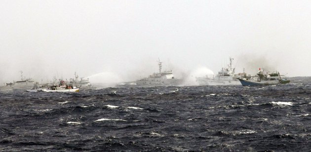 Taiwanese Coast Guard ship and Japanese Coast Guard ship fire water cannons at each other near the disputed East China Sea islets