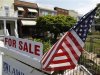 A U.S. flag decorates a for-sale sign at a home in the Capitol Hill neighborhood of Washington