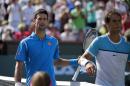 Novak Djokovic, left,of Serbia, walks off the court with Rafael Nadal, of Spain, after winning a semifinal at the BNP Paribas Open tennis tournament, Saturday, March 19, 2016, in Indian Wells, Calif. Djokovic won 7-6 (5), 6-2. (AP Photo/Mark J. Terrill)