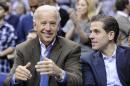 FILE - In this Jan. 30, 2010, file photo, Vice President Joe Biden, left, with his son Hunter, right, at the Duke Georgetown NCAA college basketball game in Washington. Hunter Biden is expressing regret for being discharged from the Navy Reserve amid published reports that he tested positive for cocaine. The Wall Street Journal reports that Hunter Biden failed the drug test last year and was discharged in February. In a statement issued Thursday, Oct. 16, Biden doesn't say why he was discharged. He says he's embarrassed that his actions led to his discharge and that he respects the Navy's decision. The vice president's office declined to comment.(AP Photo/Nick Wass, File)