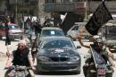 Fighters from Al-Qaeda's Syrian affiliate Al-Nusra Front drive in the northern Syrian city of Aleppo, on May 26, 2015