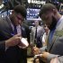 NFL draft prospects DJ Fluker, left, from Alabama, and Sheldon Richardson, of Missouri, sign autographs during their visit to the trading floor of the New York Stock Exchange, Wednesday, April 24, 2013.  (AP Photo/Richard Drew)