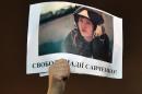 A demonstrator holds a picture of Ukranian army officer Nadiya Savchenko, with the slogan "Free Nadiya Savchenko" during a rally on Independence Square in Kiev on January 26, 2015 demanding her liberation