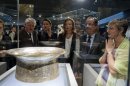 French President Francois Hollande, second right, his companion Valerie Trierweiler, center, Culture minister Aurelie Filippetti, second left, and Sophie Makariou, right, chief of Department of Islamic Arts, look at the Saint Louis baptistery, work of Master Muhammad Ibn al-Zain as they visit the new Department of Islamic Arts galleries at the Louvre museum in Paris, Tuesday Sept. 18, 2012. (AP Photo/Gonzalo Fuentes, Pool)