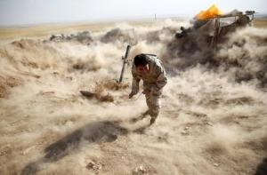 A Kurdish Peshmerga fighter launches mortar shells &hellip;
