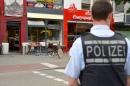A police officer stands in front of a restaurant in Reutlingen, southwestern Germany, on July 24, 2016 where a Syrian asylum-seeker killed a woman and injured two people with a machete