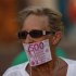 A woman covers her mouth with a fake Euro note during a protest against Spain's bailout in Malaga