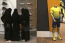 FILE - In this Friday, Dec. 11, 2015 photo, Saudi women shop at a mall in Riyadh, Saudi Arabia. The kingdom has announced on Monday, Dec. 28, 2015 a projected budget deficit in 2016 of $87 billion (327 billion riyals), as lower oil prices cut into the government's main source of revenue.(AP Photo/Khalid Mohammed, File)