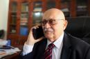 Human rights lawyer Nabil Adib speaks on the phone at his office during an interview with AFP on December 22, 2015 in the Sudanese capital Khartoum