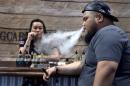 Annie Young and Dan Leano smoke e-cigarette at the Vape Summit 3 in Las Vegas, Nevada