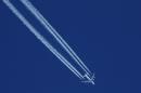 Contrails from a Lufthansa plane are seen in the sky over the ski resort of Val d'Isere