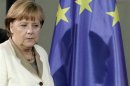 German Chancellor Merkel casts her shadow on EU flag as she arrives for news conference in Berlin