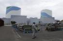 An employee of Kyushu Electric Power Co walks at the company's Sendai nuclear power plant in Satsumasendai