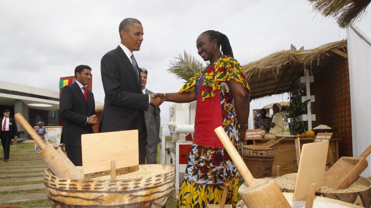 U.S. President Obama greets a rice farmer as he visits a food security expo in Dakar
