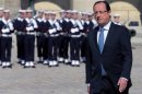 French President Francois Hollande attends a ceremony to pay tribute to late former Olympic champion Alain Mimoun in the courtyard of the Invalides in Paris
