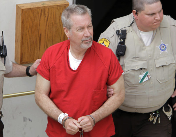 FILE - In this May 8, 2009 file photo, former Bolingbrook, Ill., police sergeant Drew Peterson leaves the Will County Courthouse in Joliet, Ill., after his arraignment on charges of first-degree murder in the 2004 death of his former wife Kathleen Savio. On Wednesday, Sept. 6, 2012, jurors at Peterson's trial withdrew to begin deliberations on whether Peterson murdered his third wife. (AP Photo/M. Spencer Green, File)
